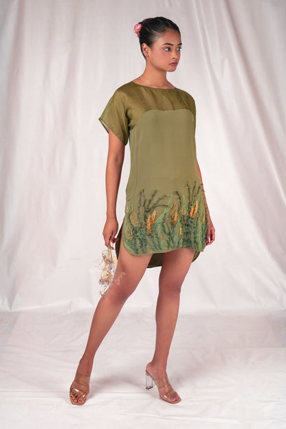 Embroidered mid-thigh length dress with a gently curved hem and embroidered motifs.