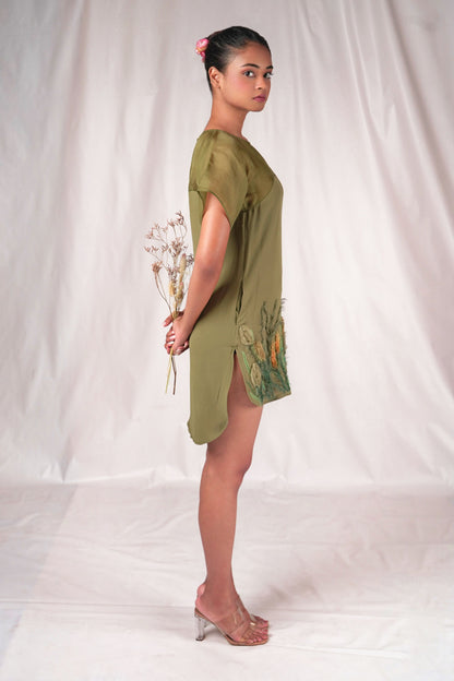 Embroidered mid-thigh length dress with a gently curved hem and embroidered motifs.