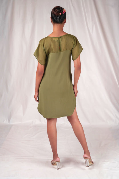 Embroidered mid-thigh length dress with a gently curved hem and embroidered motifs.